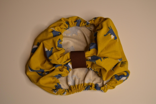 Snoods / ørebeskytter ( Gul med blå dino / stor størrelse)